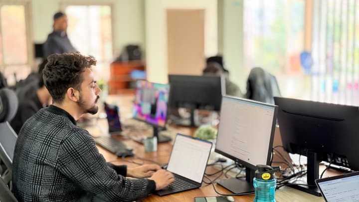 An Inseed engineer at a multi-monitor desk, mid-integration